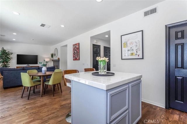 27960 Agapanthus Ln, Valencia, CA 91354 - kitchen with tile countertops, dark wood finished floors, recessed lighting, a center island, and open floor plan