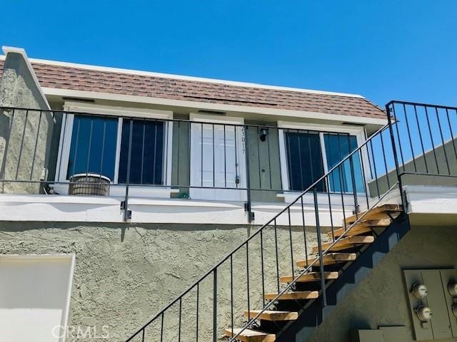23017 Via Pimiento, Mission Viejo, CA 92691 - property entrance featuring roof with shingles and mansard roof