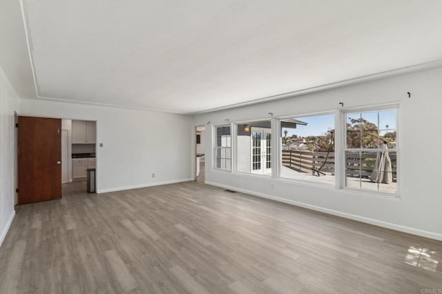 6737 San Miguel Ave, Lemon Grove, CA 91945 - unfurnished living room with baseboards and wood finished floors