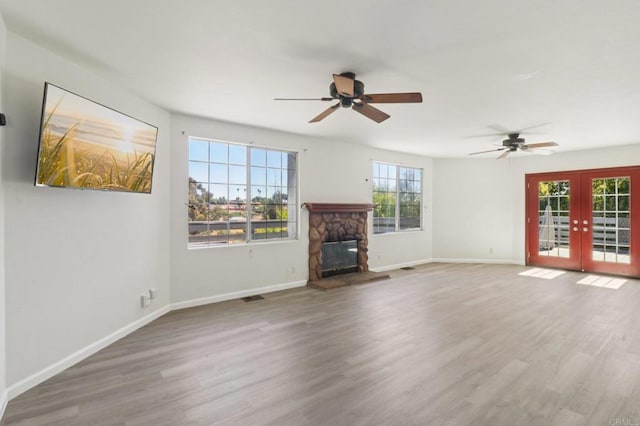 6737 San Miguel Ave, Lemon Grove, CA 91945 - unfurnished living room featuring french doors, a ceiling fan, a fireplace, and wood finished floors