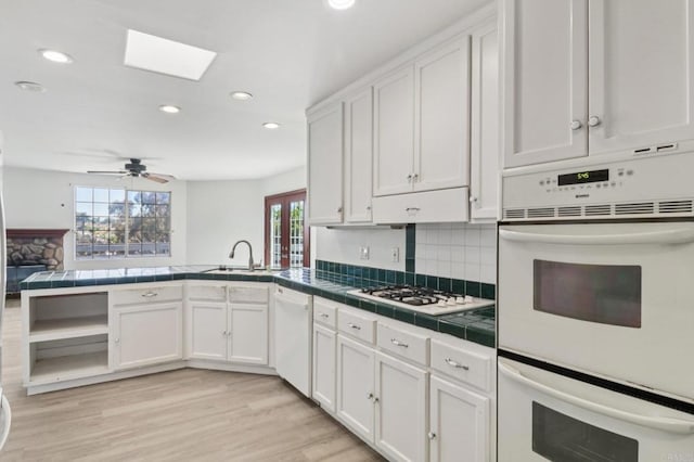 6737 San Miguel Ave, Lemon Grove, CA 91945 - kitchen with tile counters, white appliances, plenty of natural light, white cabinets, and recessed lighting