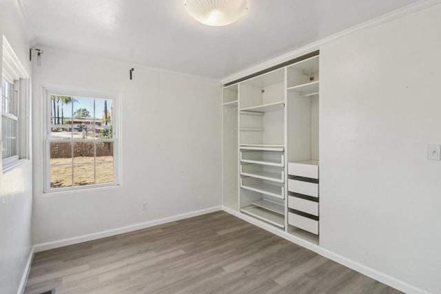 6737 San Miguel Ave, Lemon Grove, CA 91945 - unfurnished bedroom with wood finished floors, crown molding, and a closet