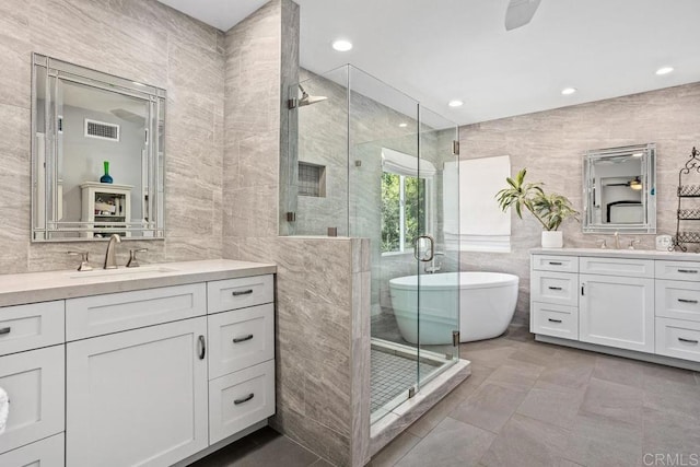 1467 Belmont Park Rd, Oceanside, CA 92057 - bathroom with tile walls, two vanities, a shower stall, a soaking tub, and recessed lighting