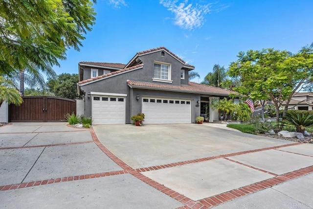 1467 Belmont Park Rd, Oceanside, CA 92057 - traditional-style house with stucco siding, driveway, a tile roof, a gate, and a garage