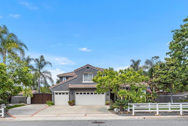 1467 Belmont Park Rd, Oceanside, CA 92057 - view of front facade with concrete driveway, stucco siding, a tiled roof, an attached garage, and a gate