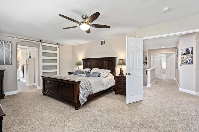 1467 Belmont Park Rd, Oceanside, CA 92057 - bedroom with light colored carpet, a barn door, and a ceiling fan