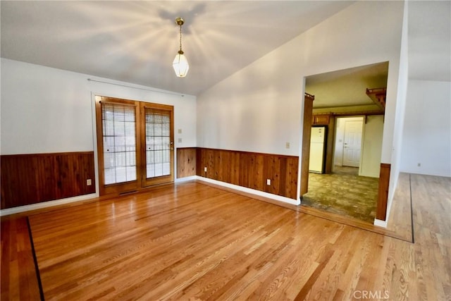 913 Northview Cir, Yreka, CA 96097 - spare room with wood finished floors, wainscoting, wooden walls, and french doors