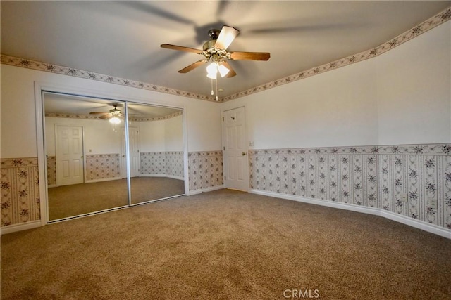 913 Northview Cir, Yreka, CA 96097 - unfurnished bedroom with carpet flooring, wallpapered walls, wainscoting, ceiling fan, and a closet