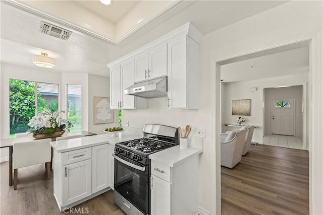 5255 La Madera Ave, El Monte, CA 91732 - kitchen featuring stainless steel gas range, under cabinet range hood, light countertops, white cabinetry, and wood finished floors
