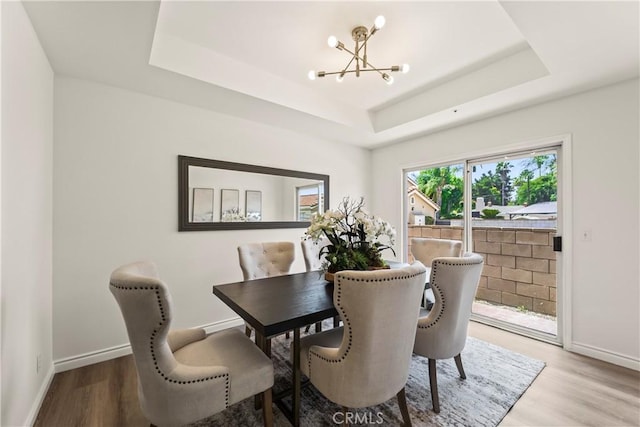 5255 La Madera Ave, El Monte, CA 91732 - dining room featuring a chandelier, a tray ceiling, and wood finished floors