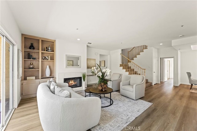 5255 La Madera Ave, El Monte, CA 91732 - living room featuring light wood finished floors, a fireplace, stairs, and recessed lighting