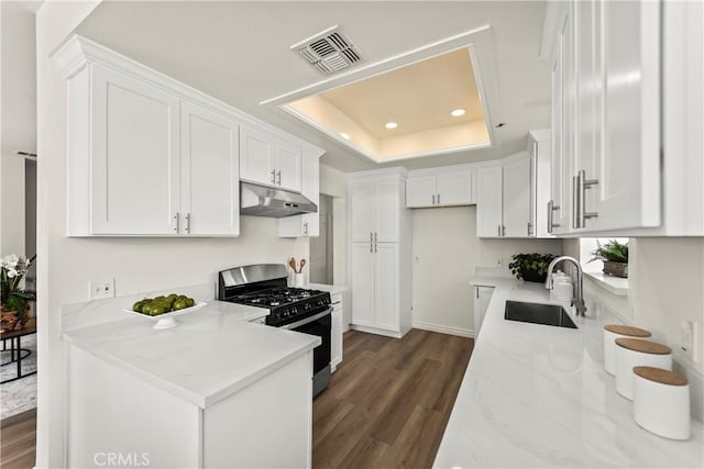 5255 La Madera Ave, El Monte, CA 91732 - kitchen with gas range, under cabinet range hood, a tray ceiling, light stone countertops, and white cabinetry
