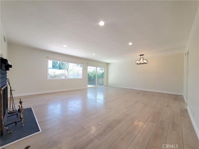 17623 Clymer St, Granada Hills, CA 91344 - unfurnished living room with a chandelier, light wood-style floors, a fireplace, and recessed lighting
