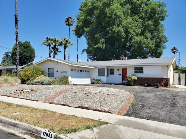 17623 Clymer St, Granada Hills, CA 91344 - single story home with driveway, an attached garage, brick siding, and stucco siding