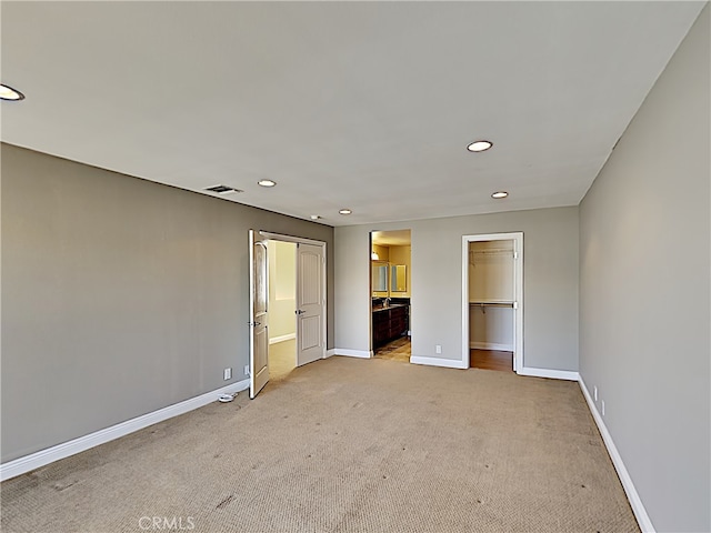 2030 Kingsbridge Way, Oxnard, CA 93035 - unfurnished bedroom featuring light colored carpet, recessed lighting, a spacious closet, connected bathroom, and a closet