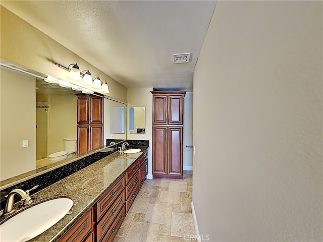 2030 Kingsbridge Way, Oxnard, CA 93035 - full bathroom with stone tile floors, double vanity, and a shower