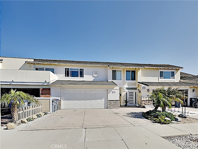 2030 Kingsbridge Way, Oxnard, CA 93035 - view of property featuring concrete driveway, stucco siding, an attached garage, and stone siding