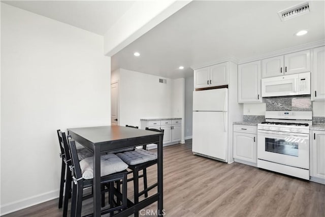 25796 Olivas Park Rd, Valencia, CA 91355 - kitchen featuring white appliances, wood finished floors, white cabinets, and recessed lighting