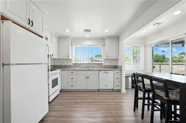 25796 Olivas Park Rd, Valencia, CA 91355 - kitchen with white appliances, plenty of natural light, white cabinets, light wood-type flooring, and recessed lighting