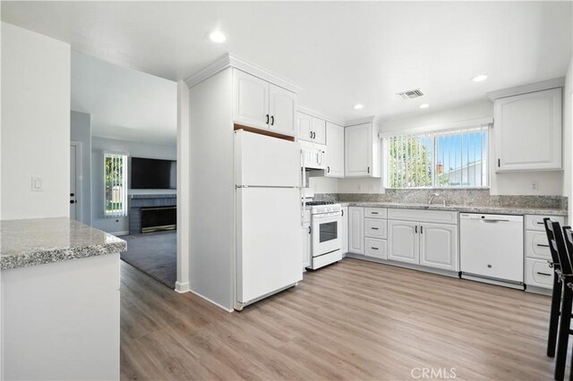 25796 Olivas Park Rd, Valencia, CA 91355 - kitchen featuring white appliances, healthy amount of natural light, light wood finished floors, white cabinetry, and recessed lighting