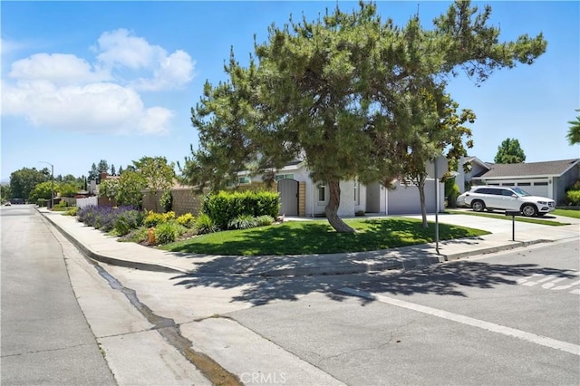 25796 Olivas Park Rd, Valencia, CA 91355 - view of front of home featuring a garage, driveway, and a front lawn