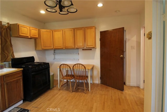 20512 Berendo Ave, Torrance, CA 90502 - kitchen with gas stove, light wood finished floors, a chandelier, light countertops, and recessed lighting