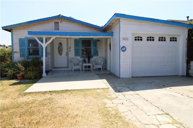 20512 Berendo Ave, Torrance, CA 90502 - view of front of property featuring concrete driveway, covered porch, and an attached garage