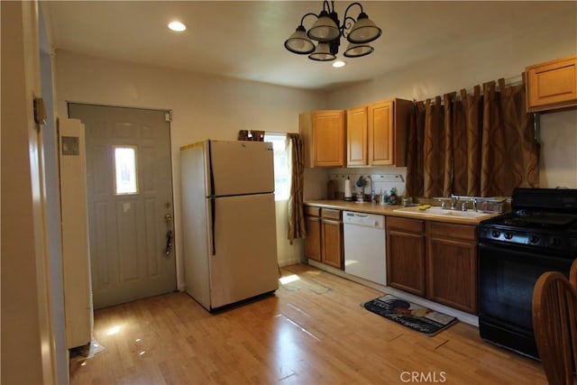 20512 Berendo Ave, Torrance, CA 90502 - kitchen with white appliances, a chandelier, light countertops, light wood-style flooring, and recessed lighting