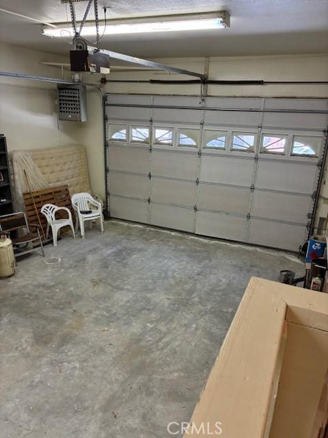 32079 Fern Dr, Running Springs, CA 92382 - garage with a garage door opener