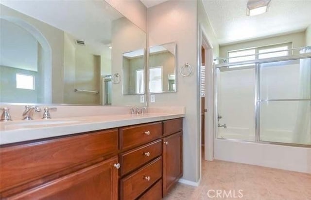 1063 S Reservoir St, Pomona, CA 91766 - full bathroom featuring double vanity, enclosed tub / shower combo, and healthy amount of natural light