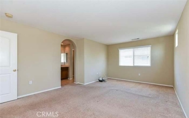 1063 S Reservoir St, Pomona, CA 91766 - unfurnished room featuring arched walkways and carpet flooring