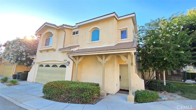 1063 S Reservoir St, Pomona, CA 91766 - view of front of home with an attached garage, stucco siding, and driveway