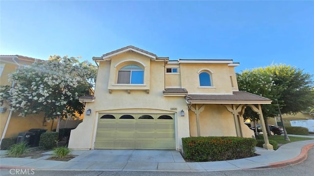 1063 S Reservoir St, Pomona, CA 91766 - view of front of property featuring stucco siding, an attached garage, and driveway