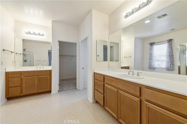 10324 Bold Red Dr, Rancho Cucamonga, CA 91730 - bathroom with a stall shower, two vanities, and a spacious closet