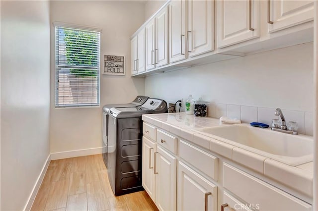48692 Pear St, Indio, CA 92201 - laundry room with cabinet space, washer and dryer, and light wood-style floors