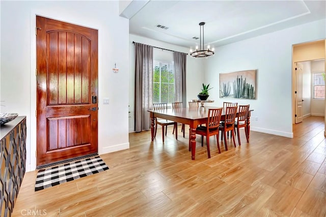 48692 Pear St, Indio, CA 92201 - dining space featuring a chandelier, plenty of natural light, and light wood finished floors