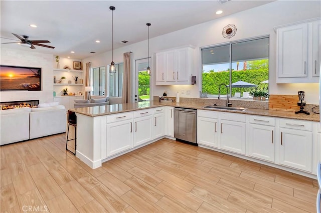 48692 Pear St, Indio, CA 92201 - kitchen featuring stainless steel dishwasher, healthy amount of natural light, open floor plan, a peninsula, and recessed lighting