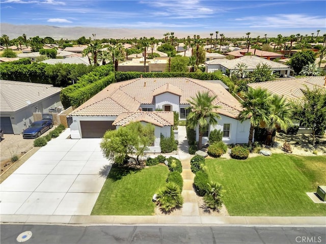 48692 Pear St, Indio, CA 92201 - mediterranean / spanish-style home with driveway, a tiled roof, a residential view, and stucco siding