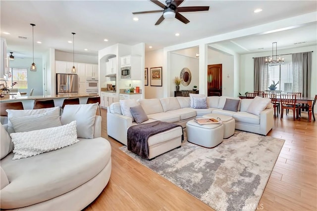 48692 Pear St, Indio, CA 92201 - living room featuring a ceiling fan, a chandelier, light wood-style flooring, and recessed lighting