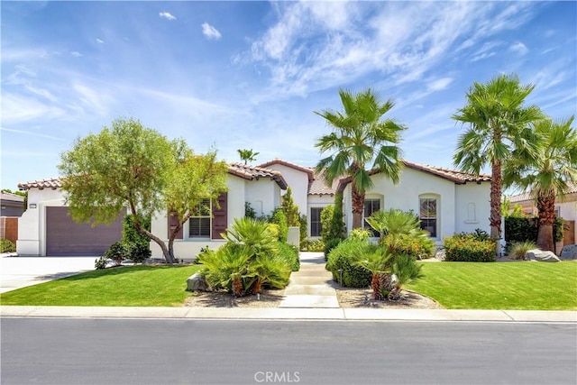 48692 Pear St, Indio, CA 92201 - mediterranean / spanish house featuring a tiled roof, stucco siding, an attached garage, and driveway