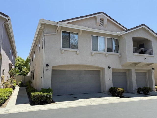 1111 Magellan Way, Chula Vista, CA 91910 - townhome / multi-family property featuring an attached garage, stucco siding, a tile roof, and a balcony