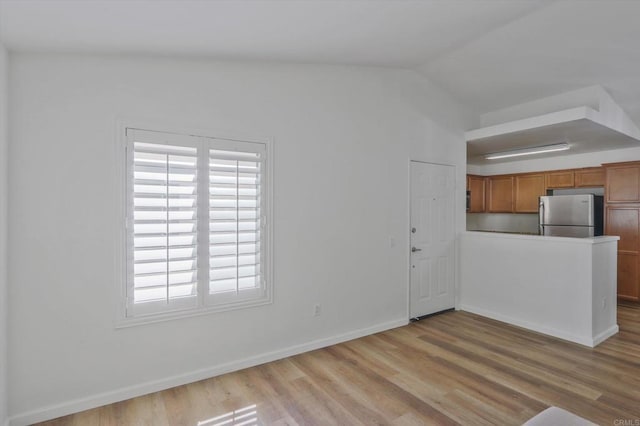 12191 Cuyamaca College Dr E Unit 210, El Cajon, CA 92019 - unfurnished living room featuring wood finished floors, healthy amount of natural light, and lofted ceiling
