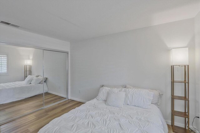 12191 Cuyamaca College Dr E Unit 210, El Cajon, CA 92019 - bedroom featuring wood finished floors and a closet