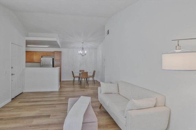 12191 Cuyamaca College Dr E Unit 210, El Cajon, CA 92019 - living room with a chandelier and light wood-style flooring