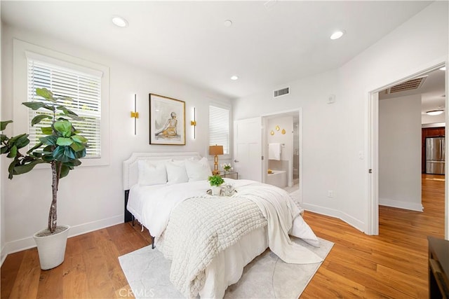 627 Deep Valley Dr Unit 410, Rolling Hills Estates, CA 90274 - bedroom featuring freestanding refrigerator, multiple windows, light wood-style floors, recessed lighting, and ensuite bathroom