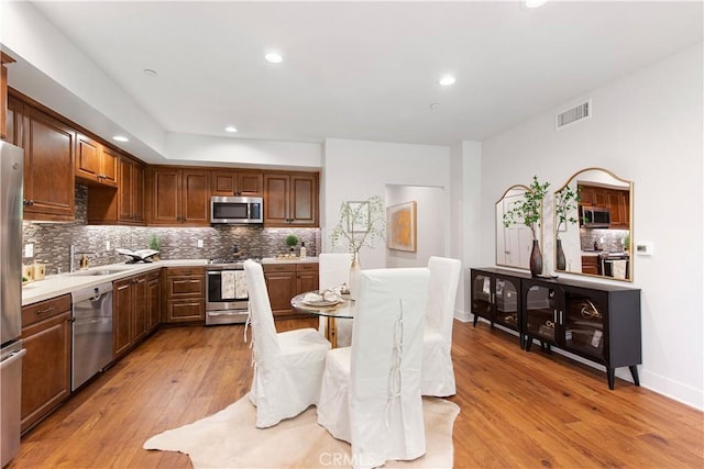 627 Deep Valley Dr Unit 410, Rolling Hills Estates, CA 90274 - kitchen with stainless steel appliances, decorative backsplash, light wood-style floors, light countertops, and recessed lighting