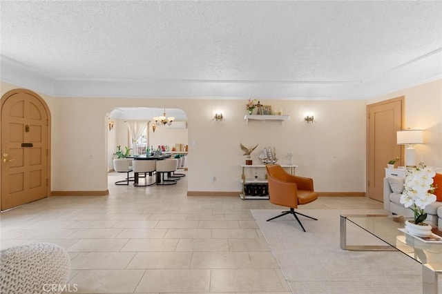 12391 Euclid St, Garden Grove, CA 92840 - living room featuring arched walkways, a textured ceiling, a chandelier, and ornamental molding