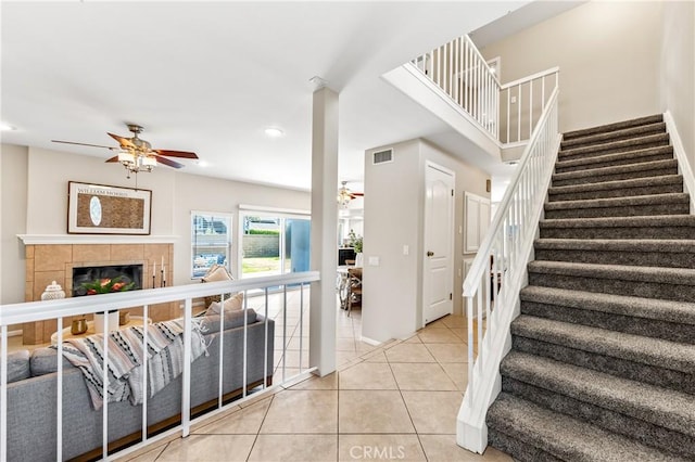 18202 Foss Ln, Huntington Beach, CA 92648 - stairway featuring a ceiling fan, tile patterned floors, a fireplace, and recessed lighting
