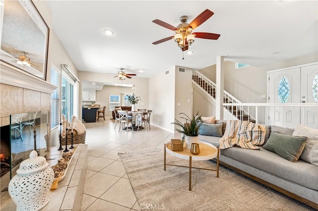 18202 Foss Ln, Huntington Beach, CA 92648 - living area featuring stairs, ceiling fan, light tile patterned flooring, a fireplace, and recessed lighting