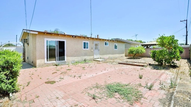 7360 Thunderbird Ln, Stanton, CA 90680 - rear view of house with stucco siding and a patio